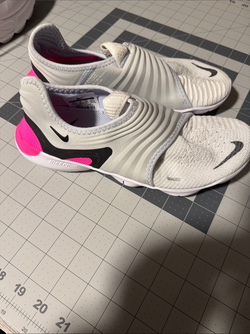 Nike Kids Slip-On Sneakers in White with Pink and Black Accents